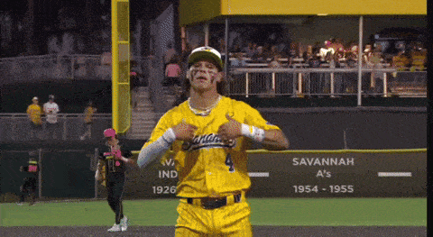 a man in a yellow savannah a 's uniform is standing on a baseball field
