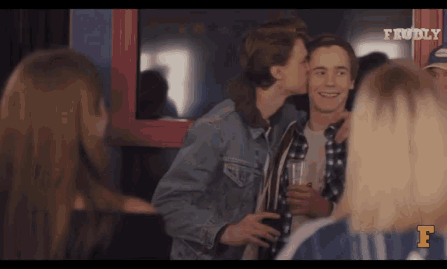 a man is kissing another man on the cheek in a scene from a tv show called frunky