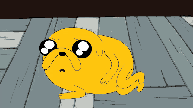 a cartoon character named jake from adventure time is crawling on the floor