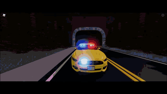 a yellow police car driving through a tunnel