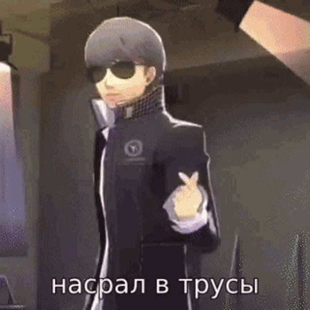 a man wearing sunglasses and a scarf is standing in a room with a cell phone in his hand .
