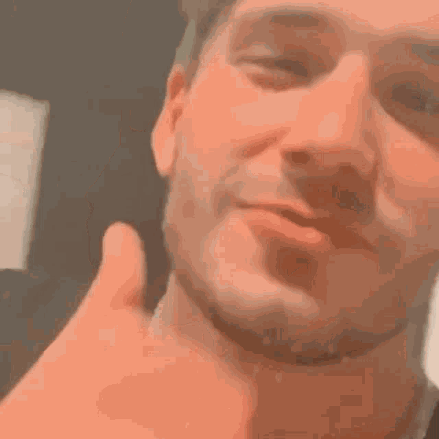 a close up of a man 's face with his eyes closed