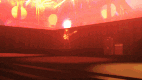 a man is playing a guitar on a stage with a crowd watching