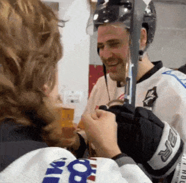 a hockey player wearing a jersey that says ' kings ' on the back