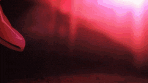 a red light is shining through a dark room