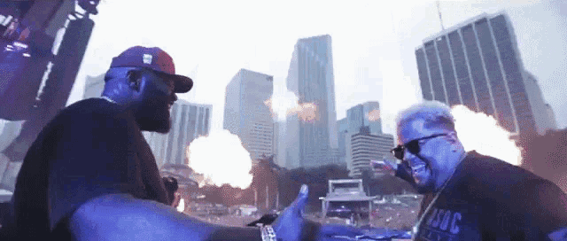 two men are standing in front of a city skyline and one of them is wearing a shirt that says zooc