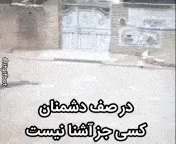a person is walking down a street in front of a building with a sign in a foreign language .