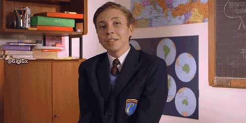 a young man in a school uniform with the letter c on his shoulder