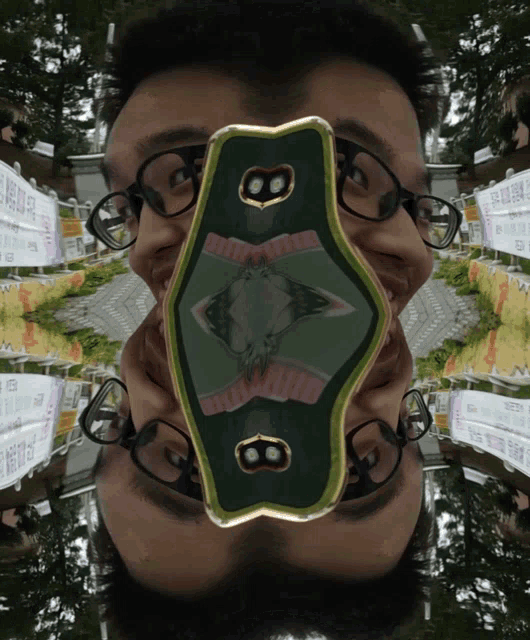 a man wearing glasses is holding a green object with the number 8 on it