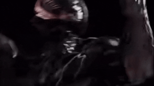 a skull is being splashed with water in a black and white photo .