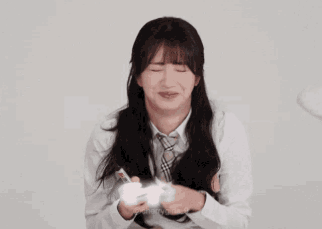 a girl covering her mouth with her hand while holding a marker that says cherry
