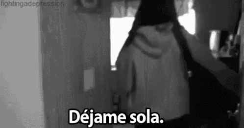 a black and white photo of a person standing in a doorway with the words `` dejame sola '' written on the bottom .