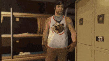 a man wearing a tank top with a bear on it is standing in front of a locker that says noob