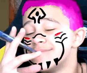 a person with pink hair has a drawing of a face on their forehead