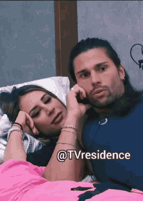 a man and a woman laying on a bed with the words @tvresidence written below them
