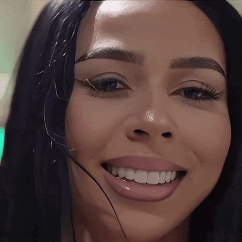 a close up of a woman 's face with a headset around her neck