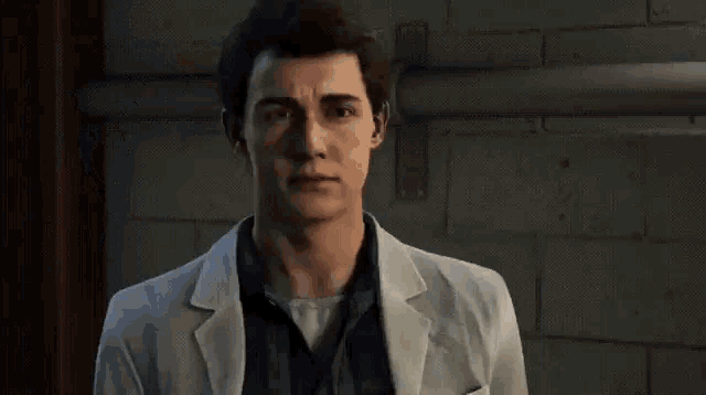 a man in a white suit is standing next to a wall and pressing a button .