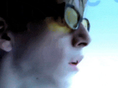 a close up of a person 's face with glasses