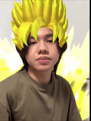 a man with a yellow wig on his head is wearing a grey shirt