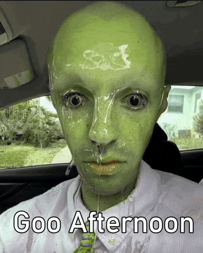 a man with a green face has goo coming out of his nose and mouth