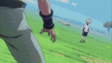 a person holding another person 's hand in a field of grass