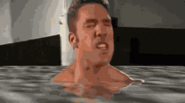 a man is taking a bath in a hot tub .