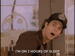 a man wearing a hat is standing in front of a window and saying i 'm on 2 hours of sleep .