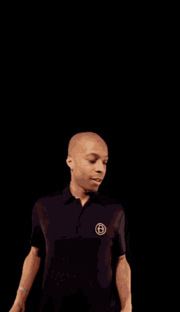 a man wearing a black shirt with a white circle on it