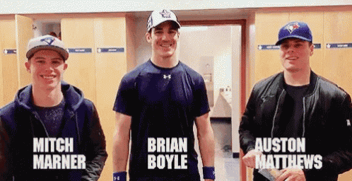 mitch marner brian boyle and auston matthews are standing in a locker room