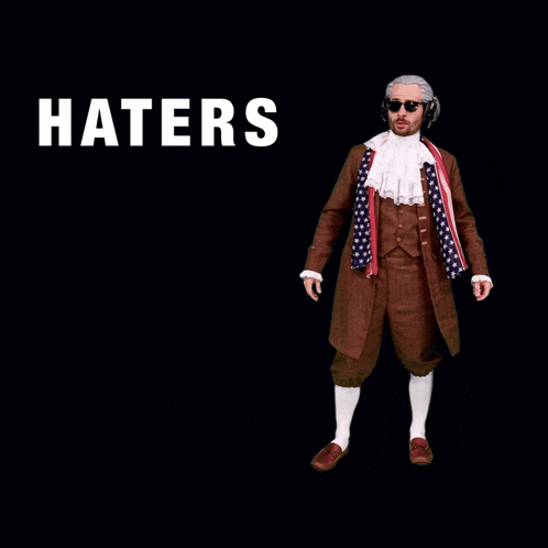a man in a suit jumping in the air with the word haters above him