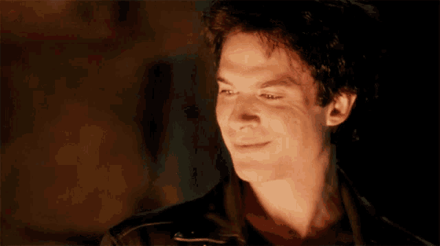 a close up of a man 's face with his eyes closed and a smile on his face