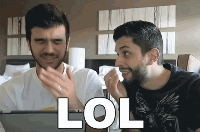 two men are looking at a tablet screen and one of them is saying lol