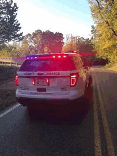 a county police vehicle is driving down a road
