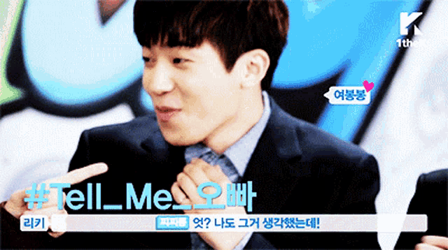 a man in a suit and tie is pointing at something and says tell me