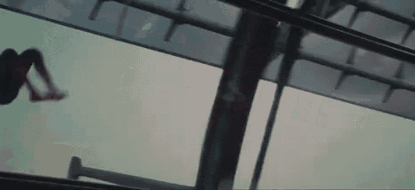 a person is riding a roller coaster in the rain while looking out of a window .