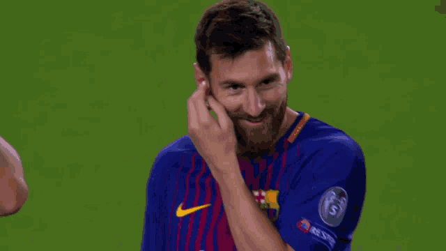 a man with a beard is wearing a blue shirt with the number 5 on the sleeve