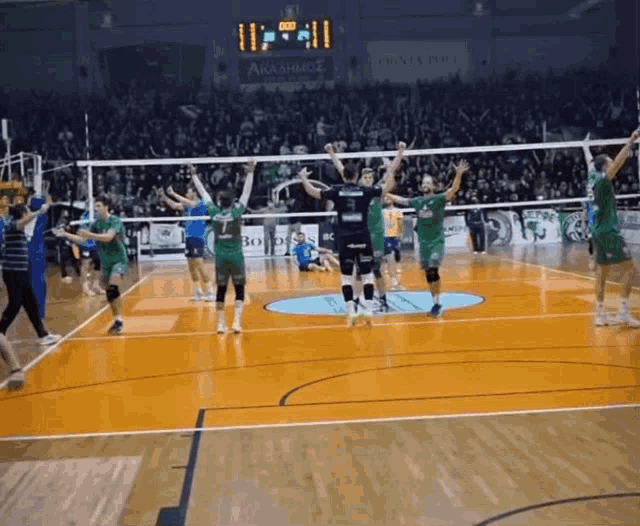 a volleyball game is being played in front of a crowd and a scoreboard that says 11:11