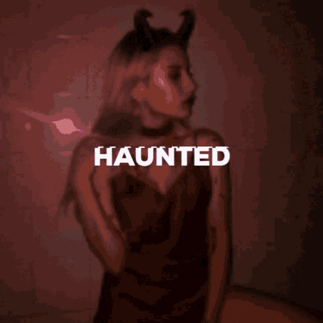 a woman in a devil costume has the word haunted on her face