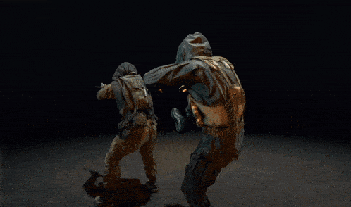 a man in a gas mask is holding another man 's hand