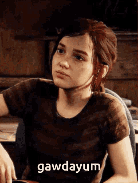 a girl is sitting in a chair with the word gawdayum written on her face