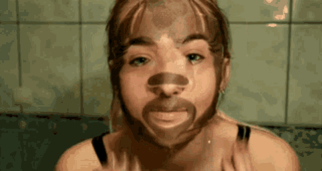 a woman with a beard on her face is making a funny face