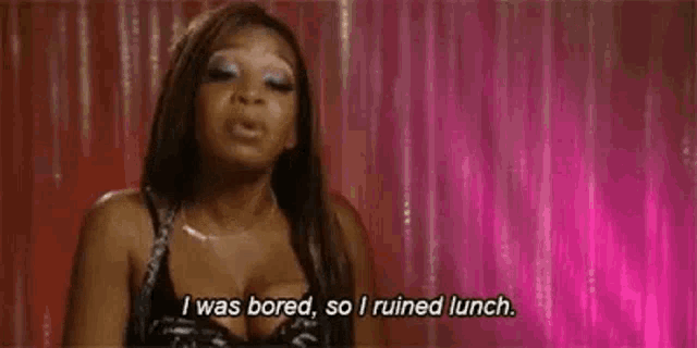 a woman is standing in front of a pink curtain and saying `` i was bored , so i ruined lunch '' .