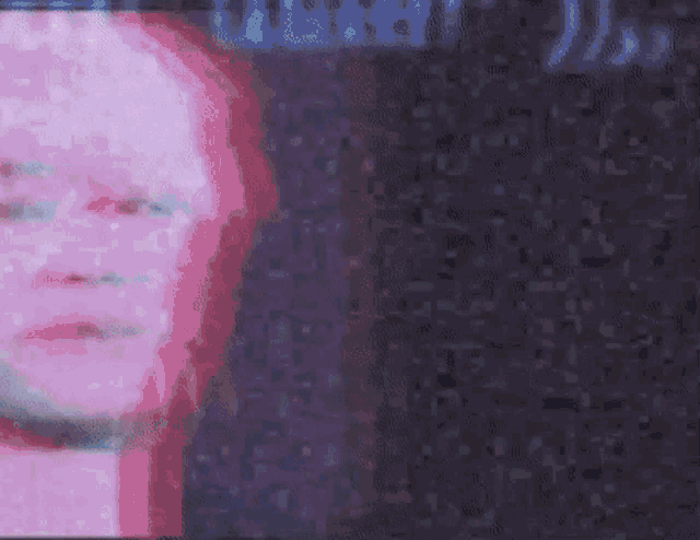 a close up of a person 's face with a blurred background and a pink and blue glow .