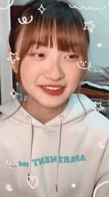 a girl wearing a white hoodie that says ' ane ' on it