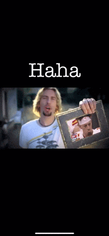 a man is laughing while looking at a picture frame with the word haha written above him