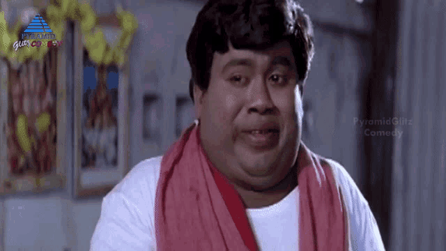 a fat man with a red scarf around his neck is making a funny face