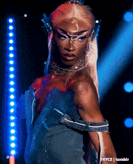 a woman in a blue dress is standing in front of a row of blue lights with t4yce tumblr in the lower right corner