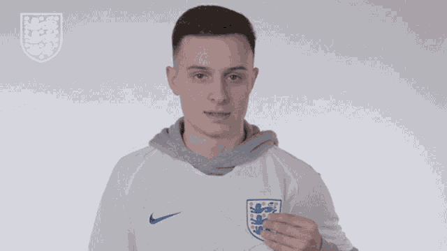 a man wearing a white nike shirt with a lion on the chest