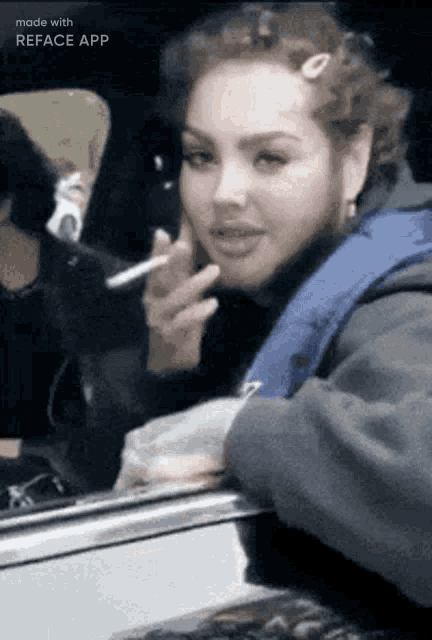 a woman with a beard is smoking a cigarette in a car ..