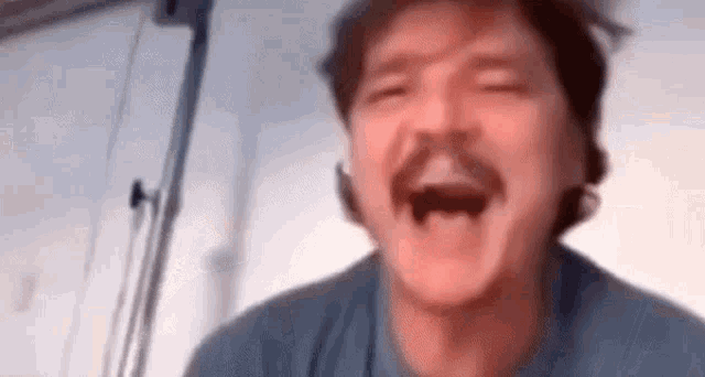 an animated gif displaying a mustached man as he transitions from laughing to crying